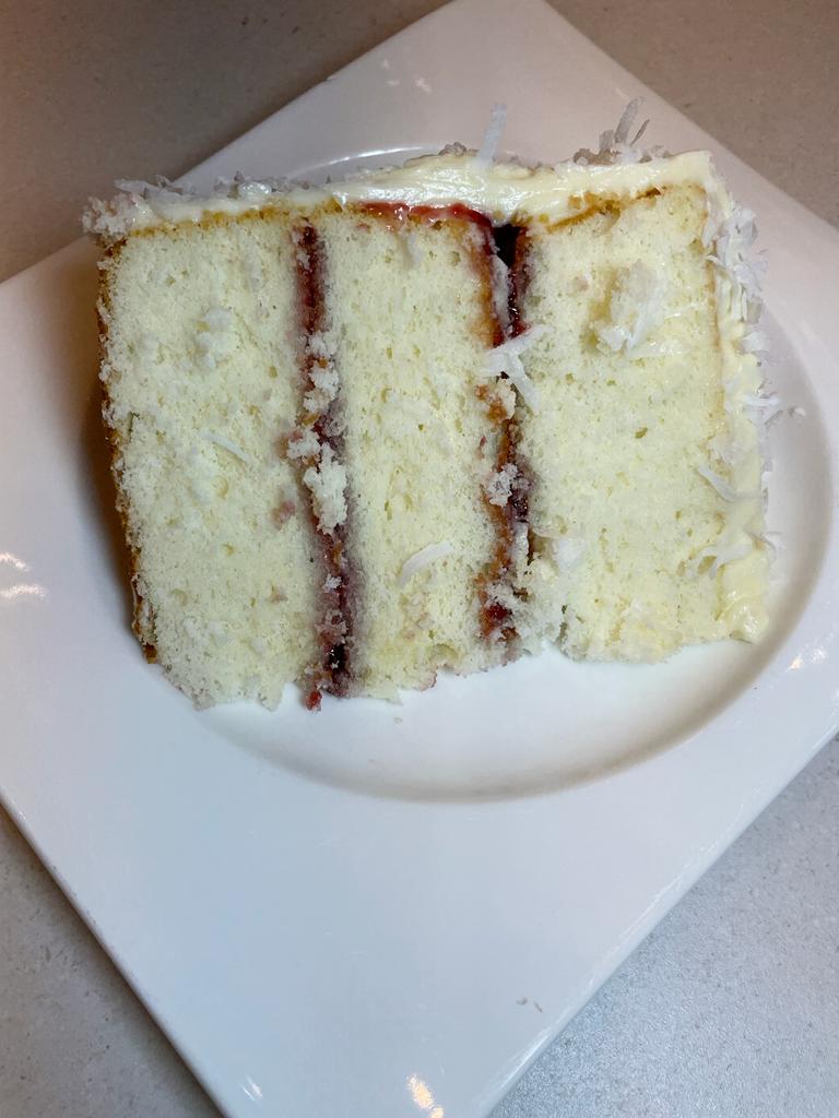 Layered coconut and raspberry cake recipe by home cooking with julie neville