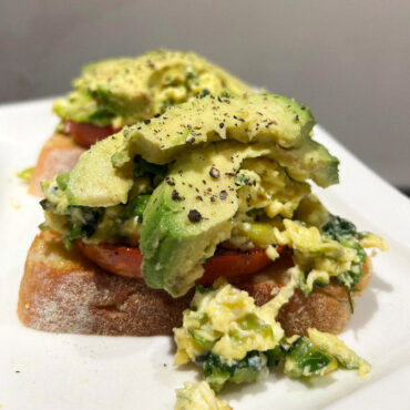 Green Scrambled Eggs On Toasted Sourdough Bread